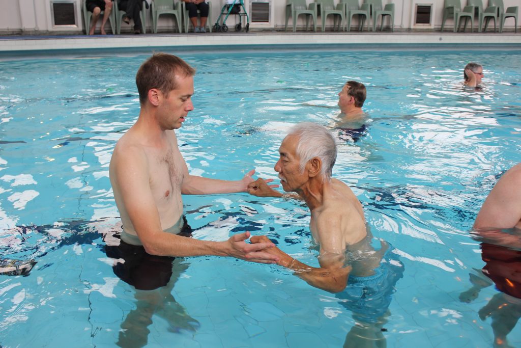 Image of a patient in the water with their therapist